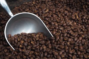 Roasted coffee beans and stainless steel coffee bean scoop