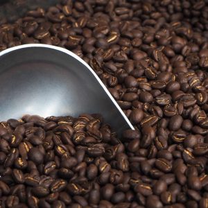 Roasted coffee beans and stainless steel coffee bean scoop